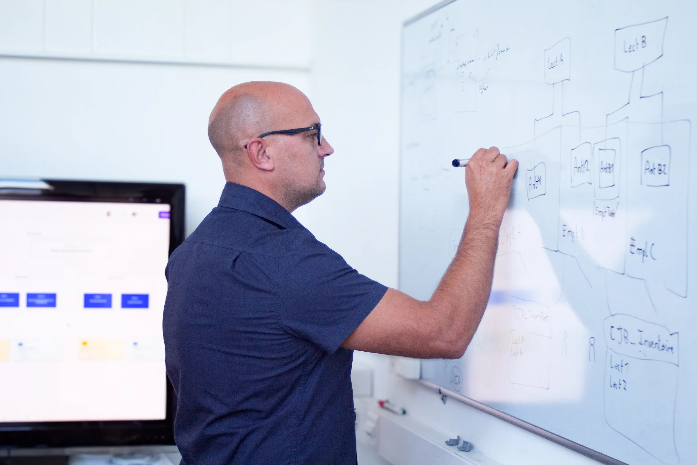 Un employé de Solid Solutions écrivant sur un tableau