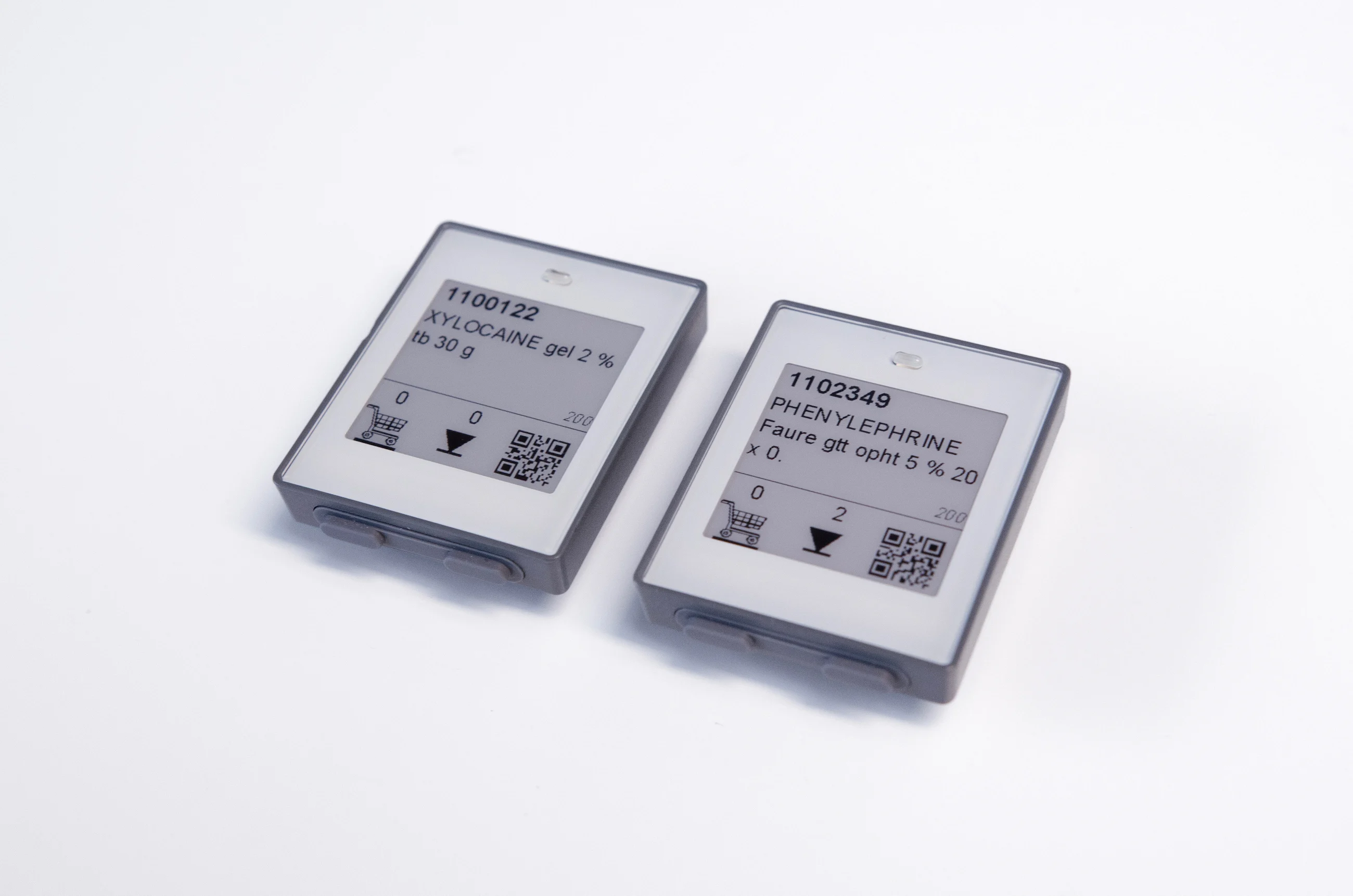 Two electronic labels side by side displaying various information