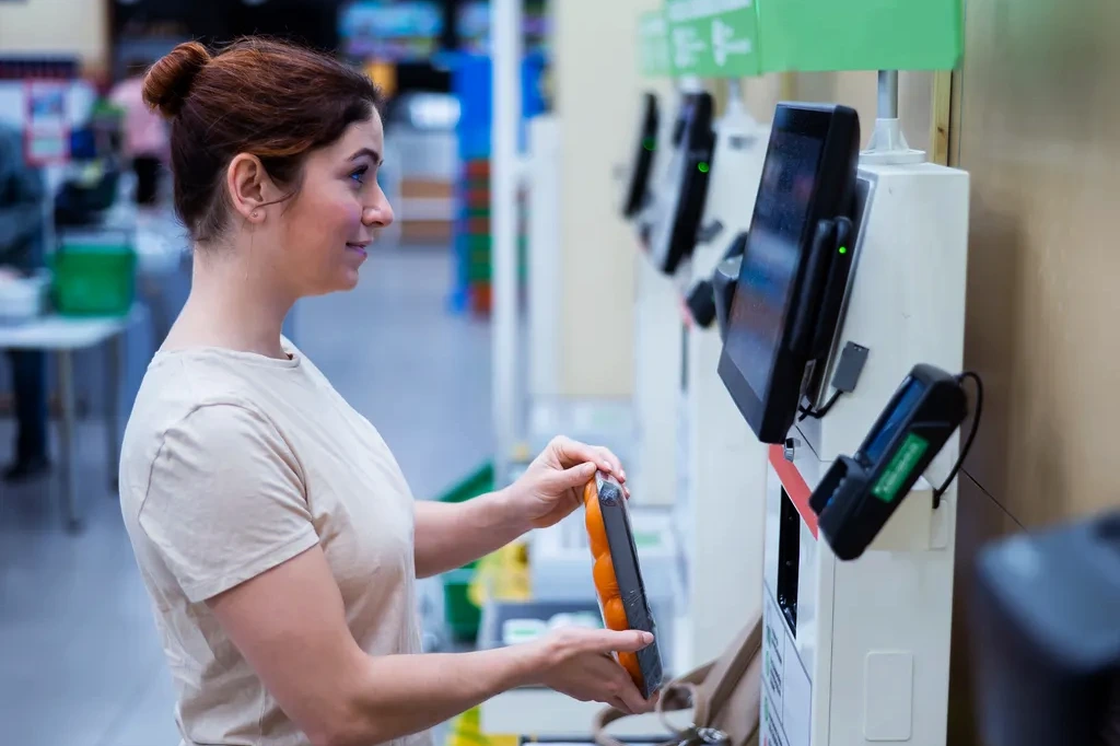 Donna alla cassa automatica che scansiona un prodotto farmaceutico