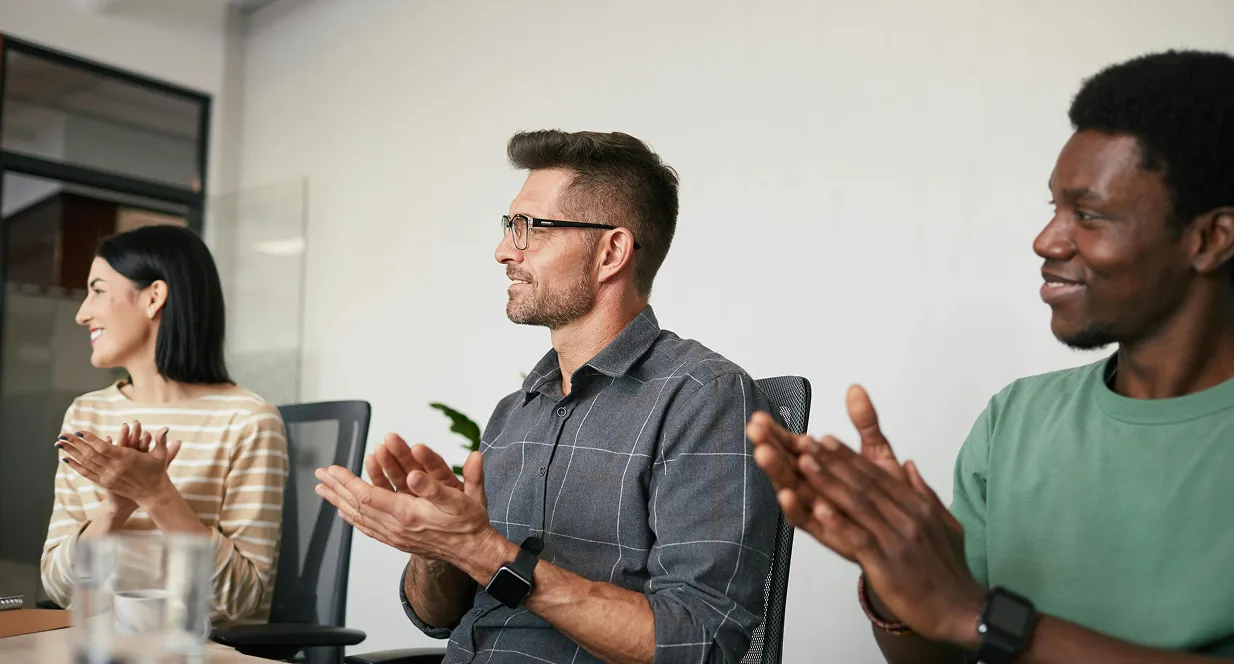 Team applauding during a meeting or presentation
