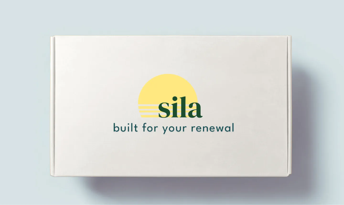 White box with a yellow sun graphic and the text 'sila built for your renewal' on the lid.