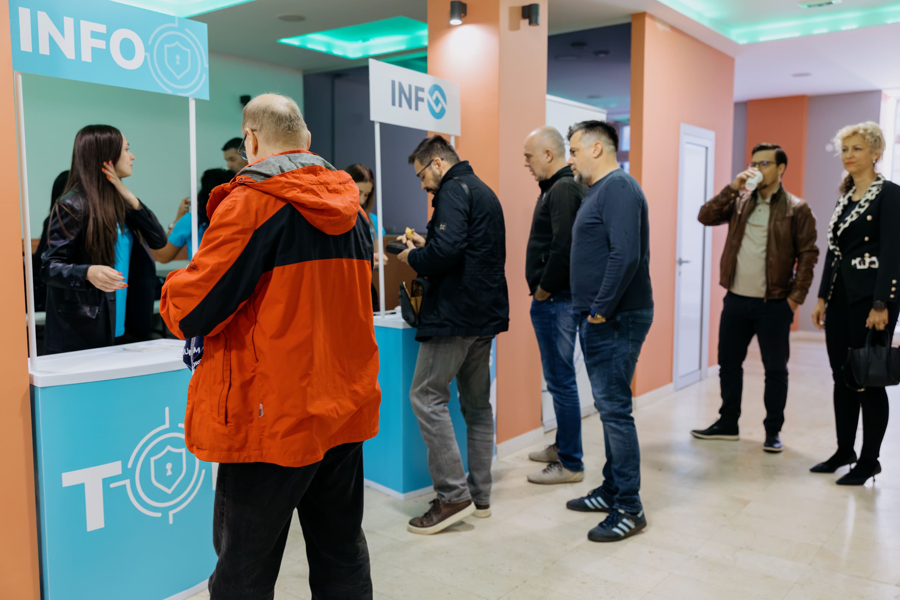People in front of the info stand at the Top conference