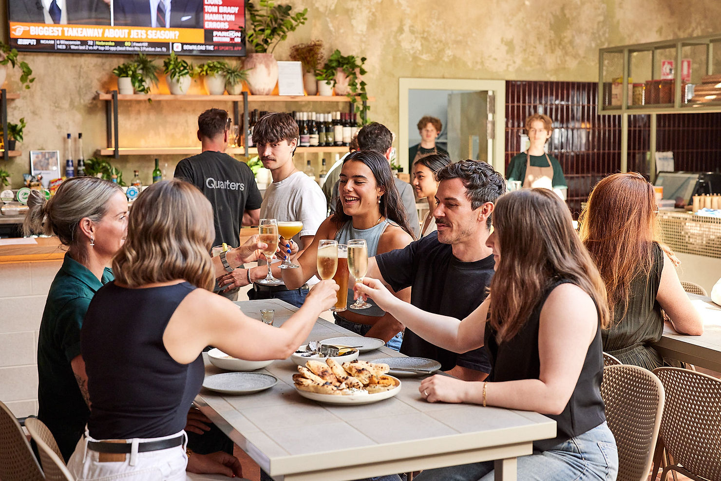 Friends cheering with drinks in the afternoon sun at Auburn Hotel, Melbourne, Australia, captured by Tableside Creatives.