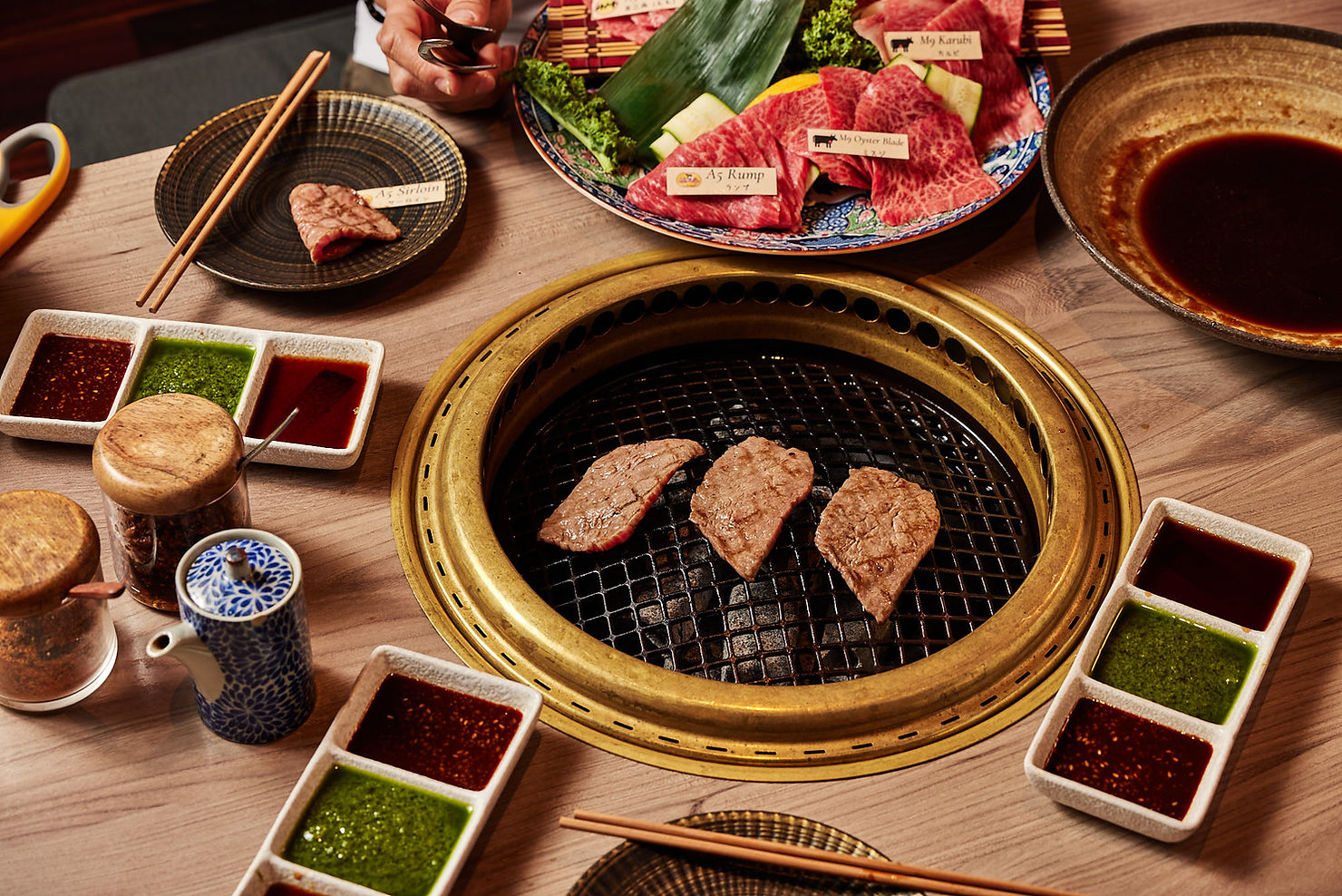 Japanese BBQ table cooking Wagyu beef over hot coals at Wagyu Ya, South Yarra.