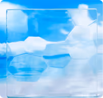 Close-up of a translucent plastic protective face shield against a blue sky background with white clouds.