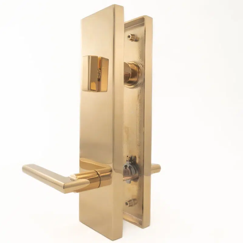 Polished brass door lever handle with rectangular faceplate and locking mechanism.