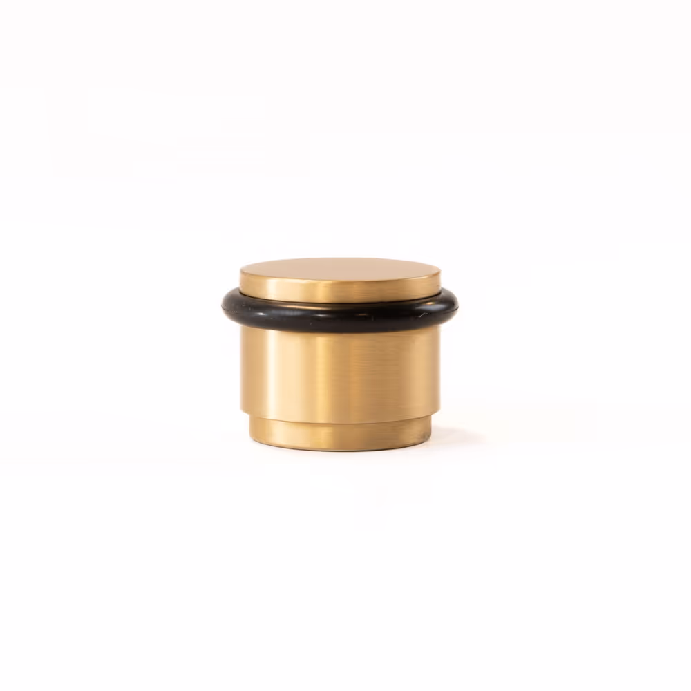 Brushed brass doorstop with a black rubber bumper ring, photographed on a white background.
