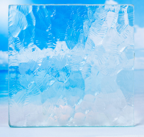 Close-up of a transparent ice cube showing water droplets and air bubbles inside.