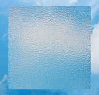 Textured translucent square glass panel standing against a blue sky background with white clouds.