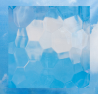 Transparent hexagonal glass tiles with a blue sky and white clouds visible behind them.