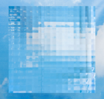 Clear glass vase with vertical ripple texture on a reflective white surface with a beach and sky background.