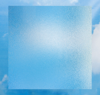 Frosted glass panel with textured surface against a blue sky background with clouds.