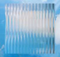 Transparent glass block with reflections of a blue sky and white clouds.