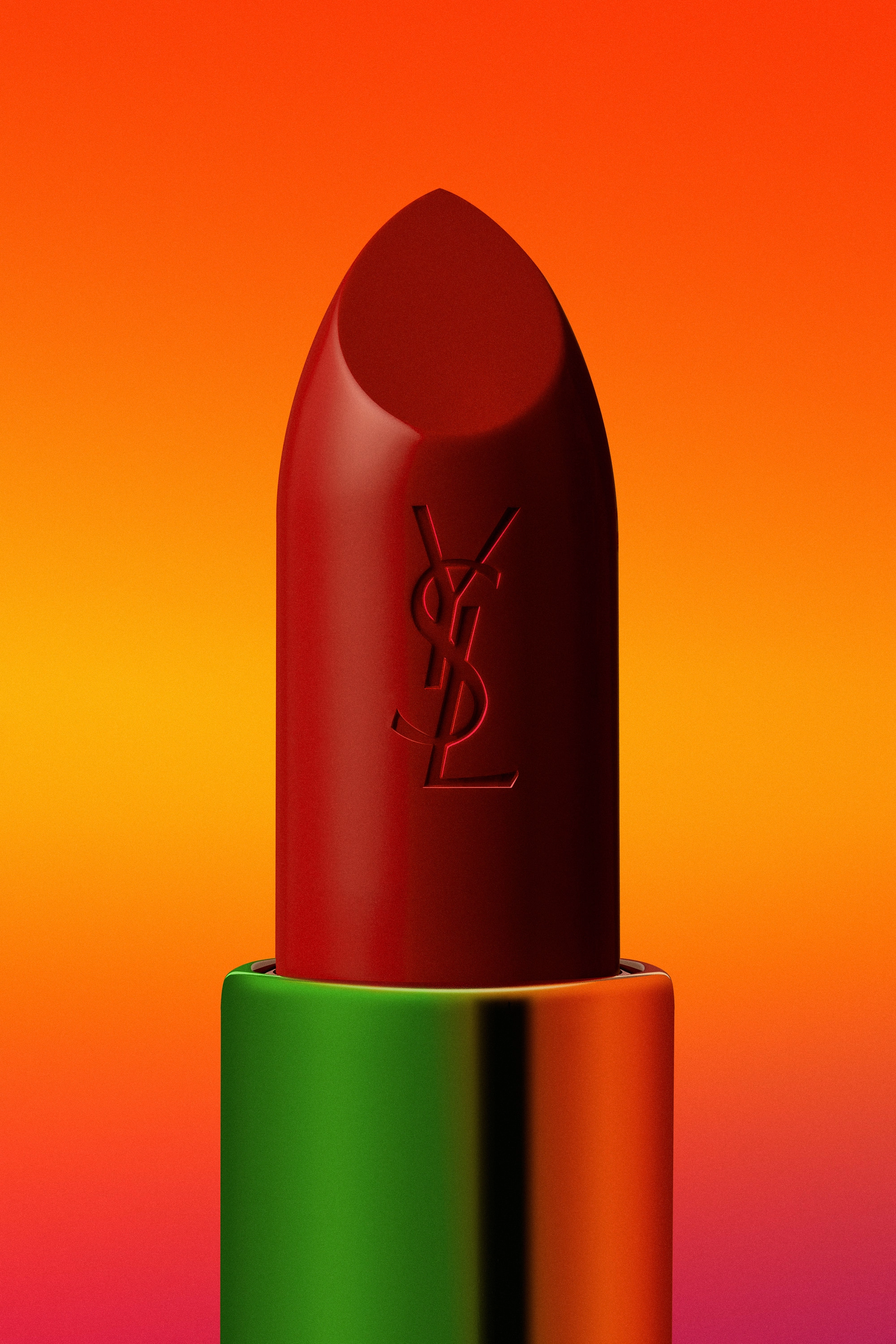 Close-up of a red Yves Saint Laurent lipstick with green and orange metallic casing against a vibrant orange to pink gradient background.
