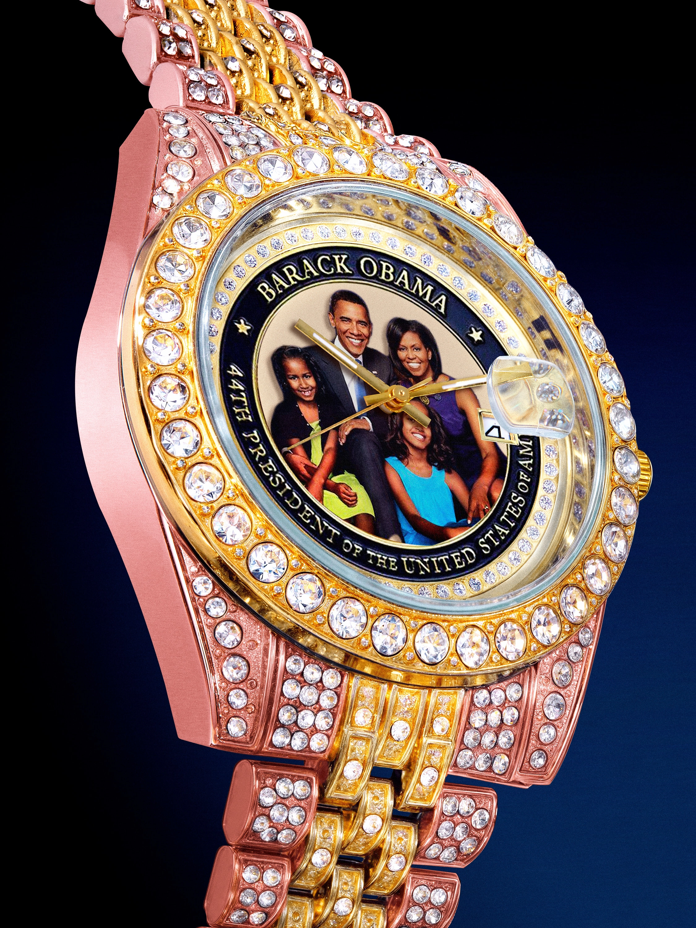Gold and rose gold watch encrusted with diamonds featuring a photo of Barack Obama and family with text reading 'Barack Obama 44th President of the United States of America'.