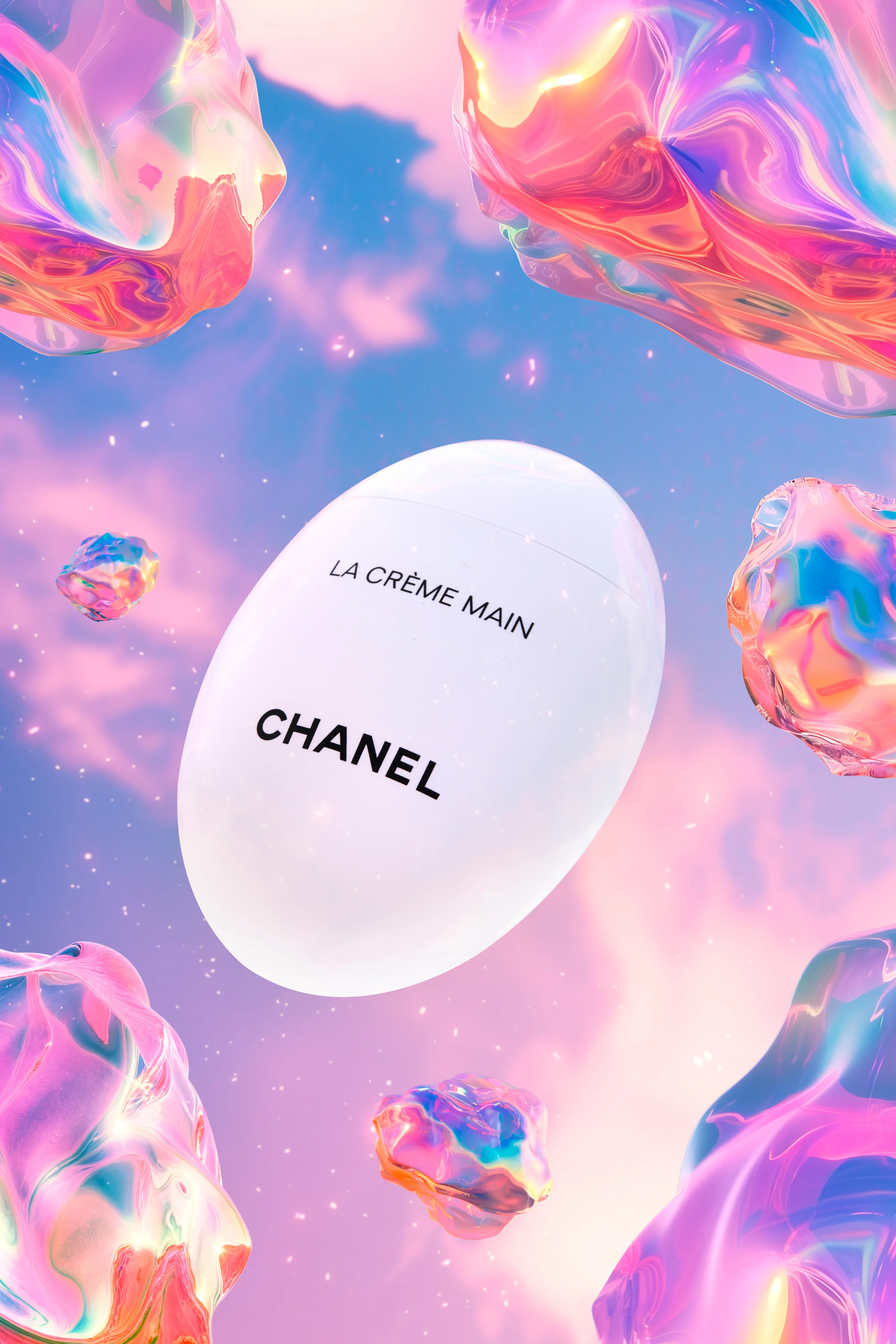 White egg-shaped container of Chanel La Crème Main hand cream surrounded by colorful iridescent bubbles against a purple and pink sky background.