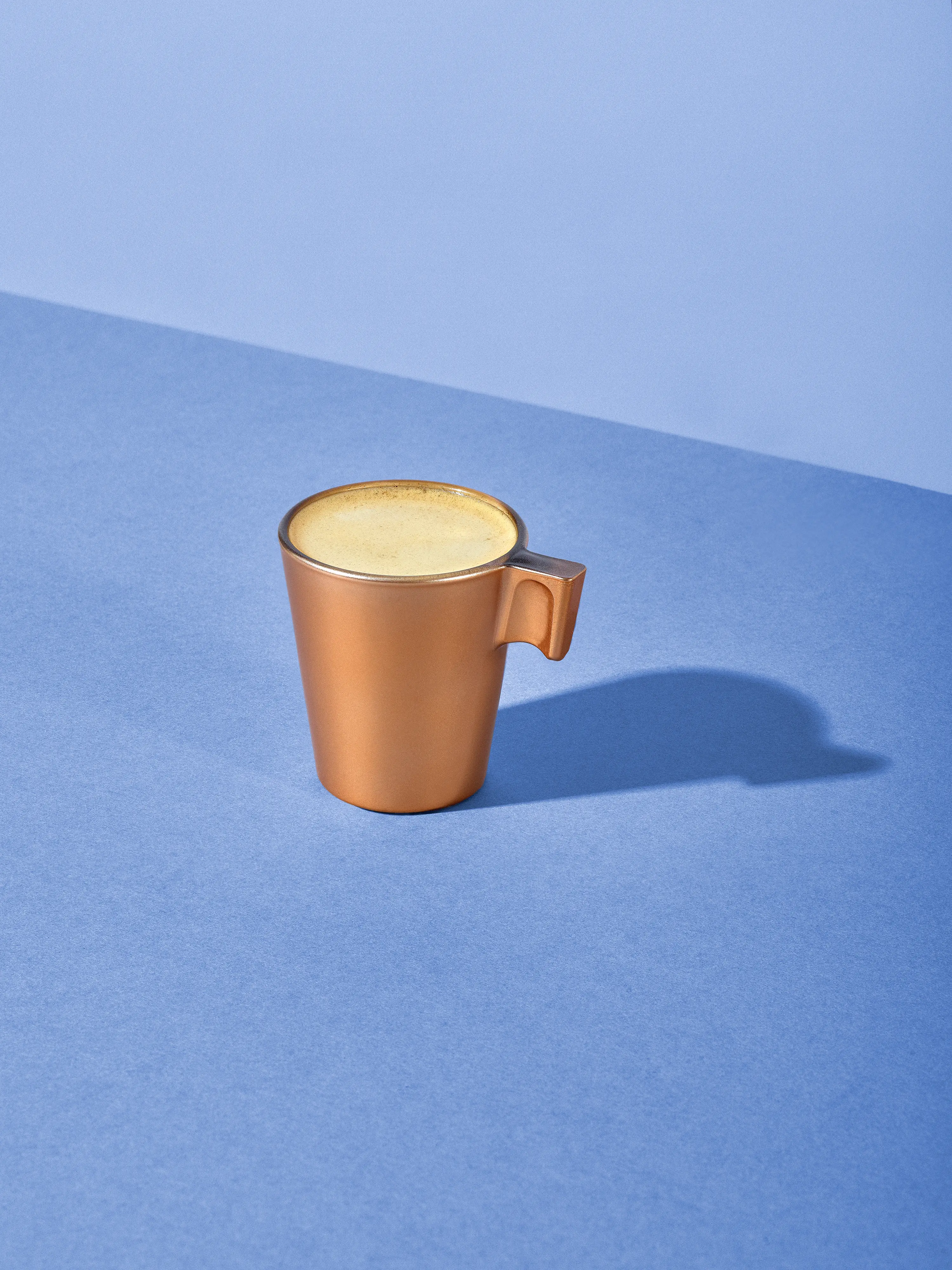 Two bottles of Meteor IPA beer with condensation on a glass table surrounded by snacks, a bottle opener, and a record player in a cozy room.