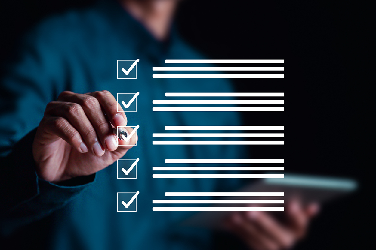 Person checking off completed tasks on digital checklist with checkboxes