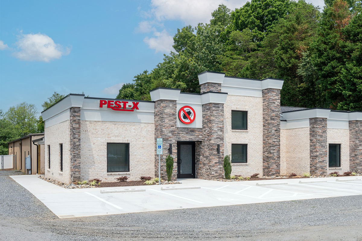 Modern Pest-X building with stone facade and no pests allowed sign