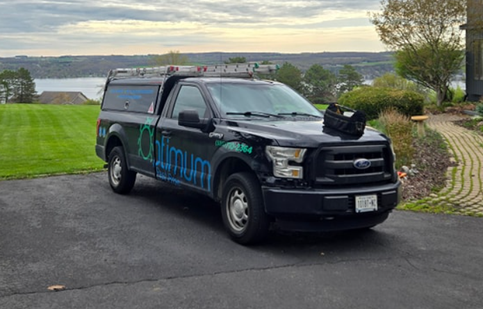Black Ford pickup truck with Climum logo parked on asphalt near grassy landscape
