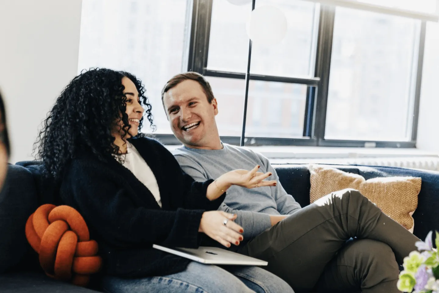 People in front of windows on couch