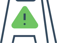 Green triangular warning sign with an exclamation mark on a black stand.