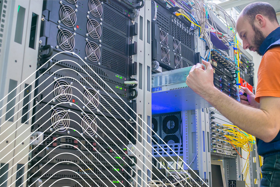 Technician installing or maintaining a server in a data center rack with network cables and cooling fans.