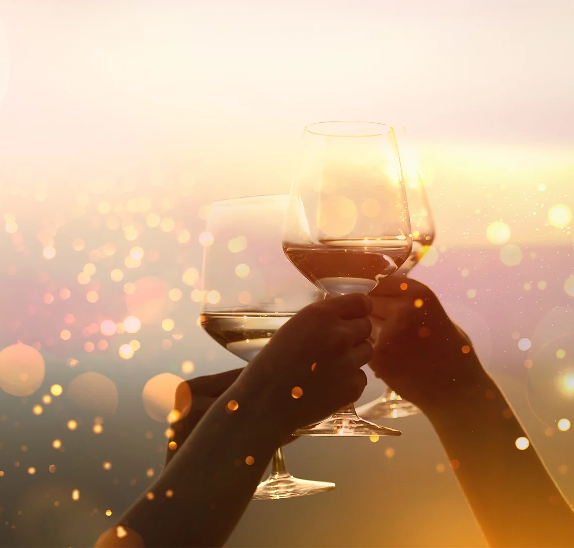 Three hands cheering their glasses on a luminous background