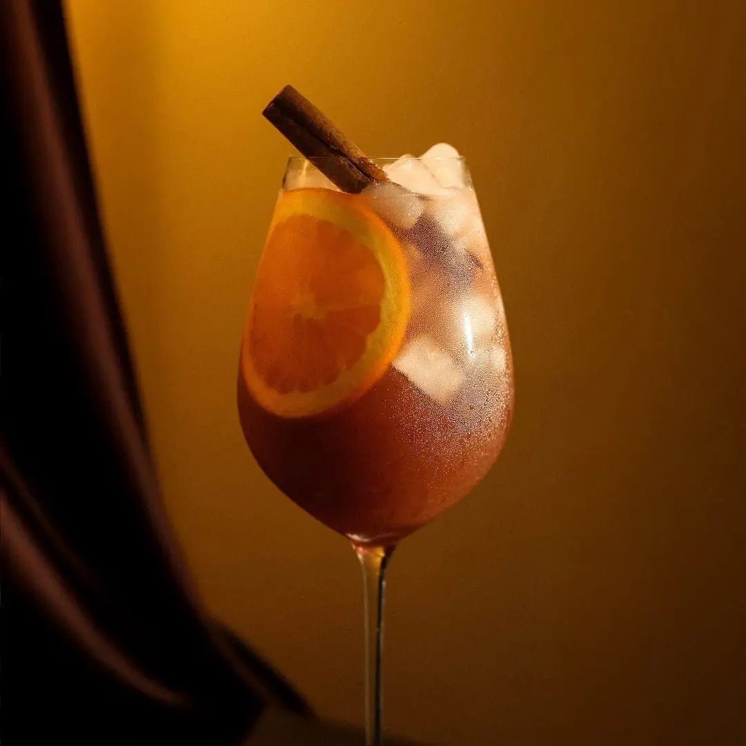 Non-alcoholic Vermouth Sangria cocktail on orange background
