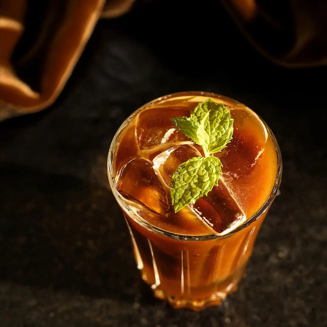 Non-alcoholic Coffee lemonade cocktail on a black surface