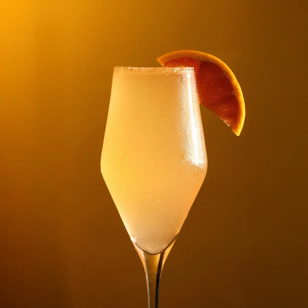 Non-alcoholic Sparkling wine and lychee cocktail on an light background