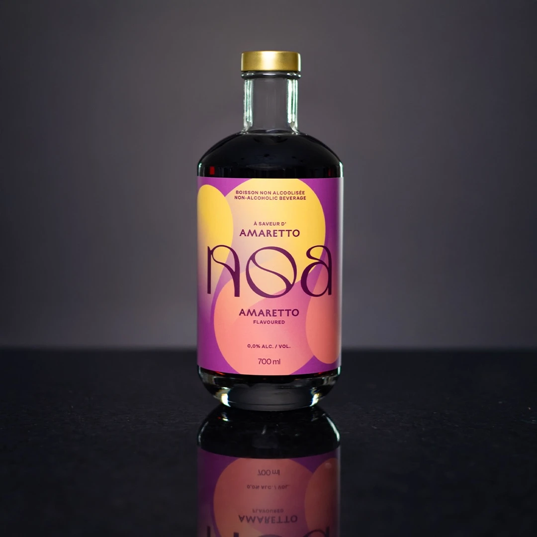 700 ml Bottle of non-alcoholic NOA Amaretto on a dark background