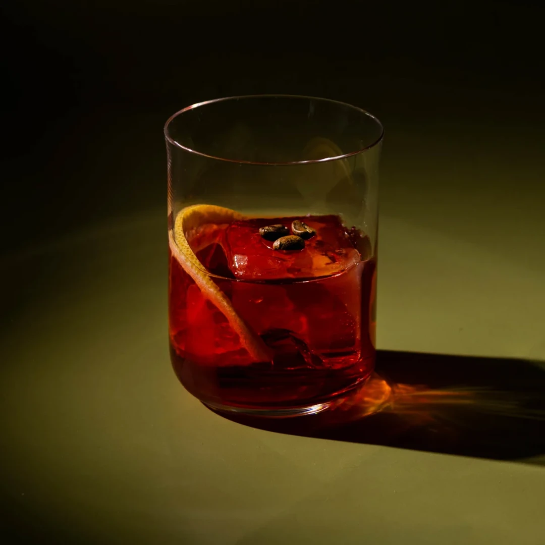 Non-alcoholic Espresso Martini cocktail on an olive background