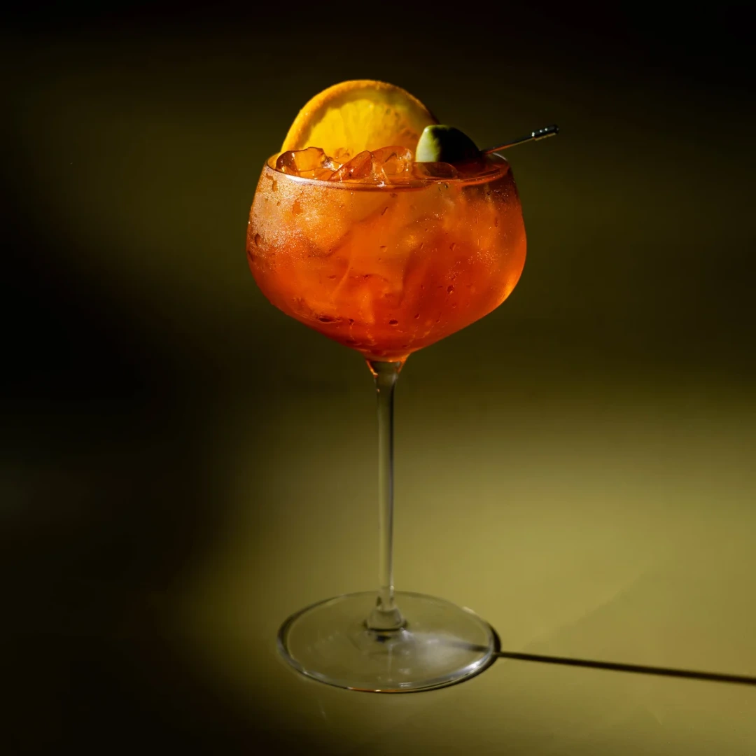 Non-alcoholic Classic Spritz cocktail on an olive background