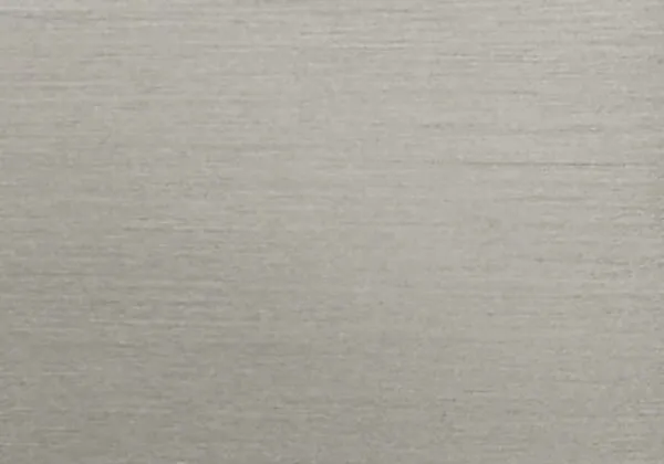 A close-up of a brushed nickel swatch, showcasing its smooth and reflective surface.