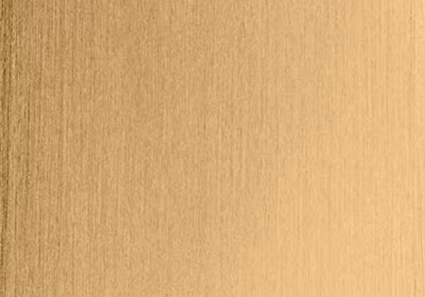 A close-up of a bronze swatch, showcasing its smooth and reflective surface.