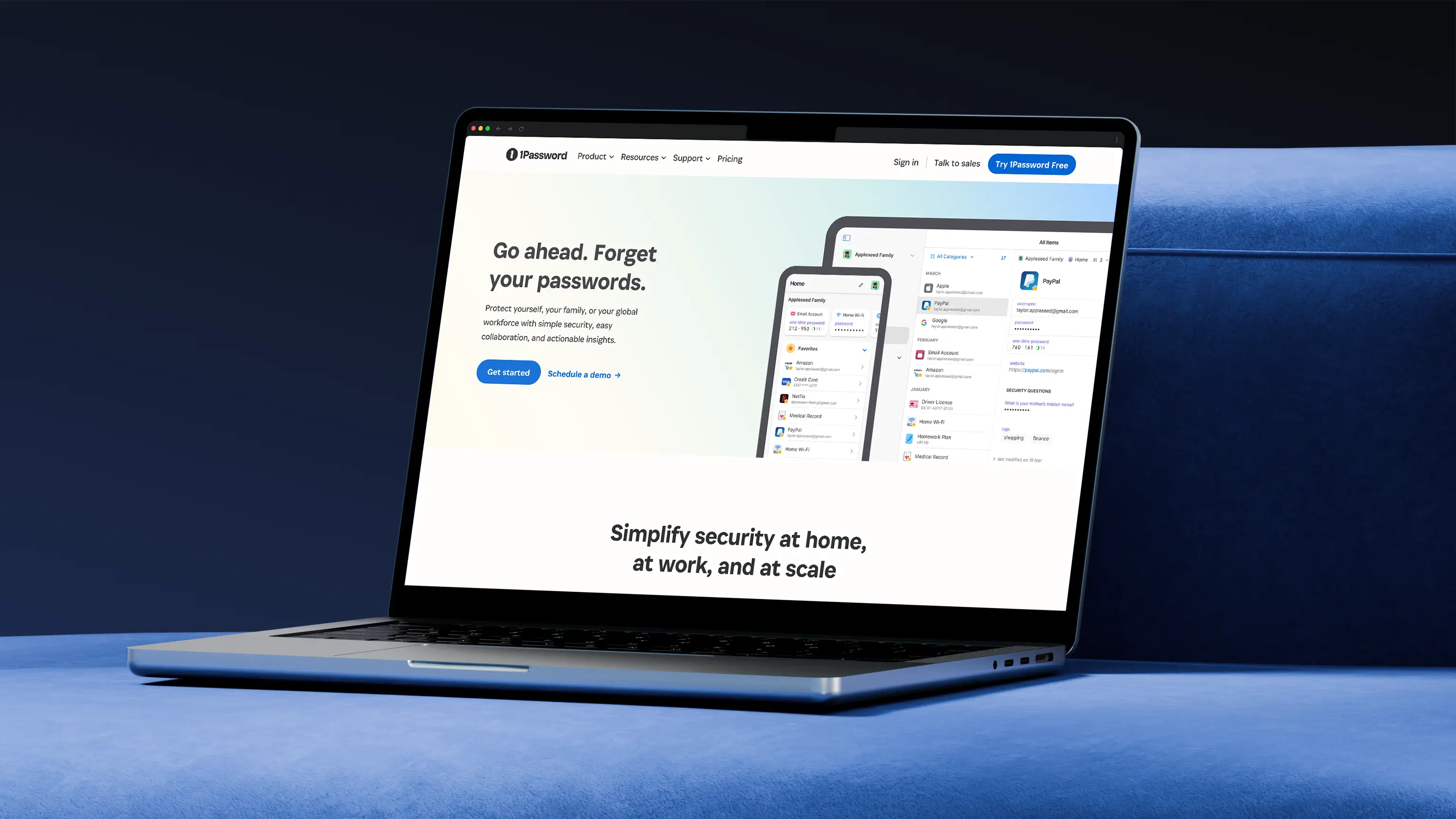 Open laptop on blue surface displaying 1Password website with a message to forget passwords and simplify security at home, work, and scale.