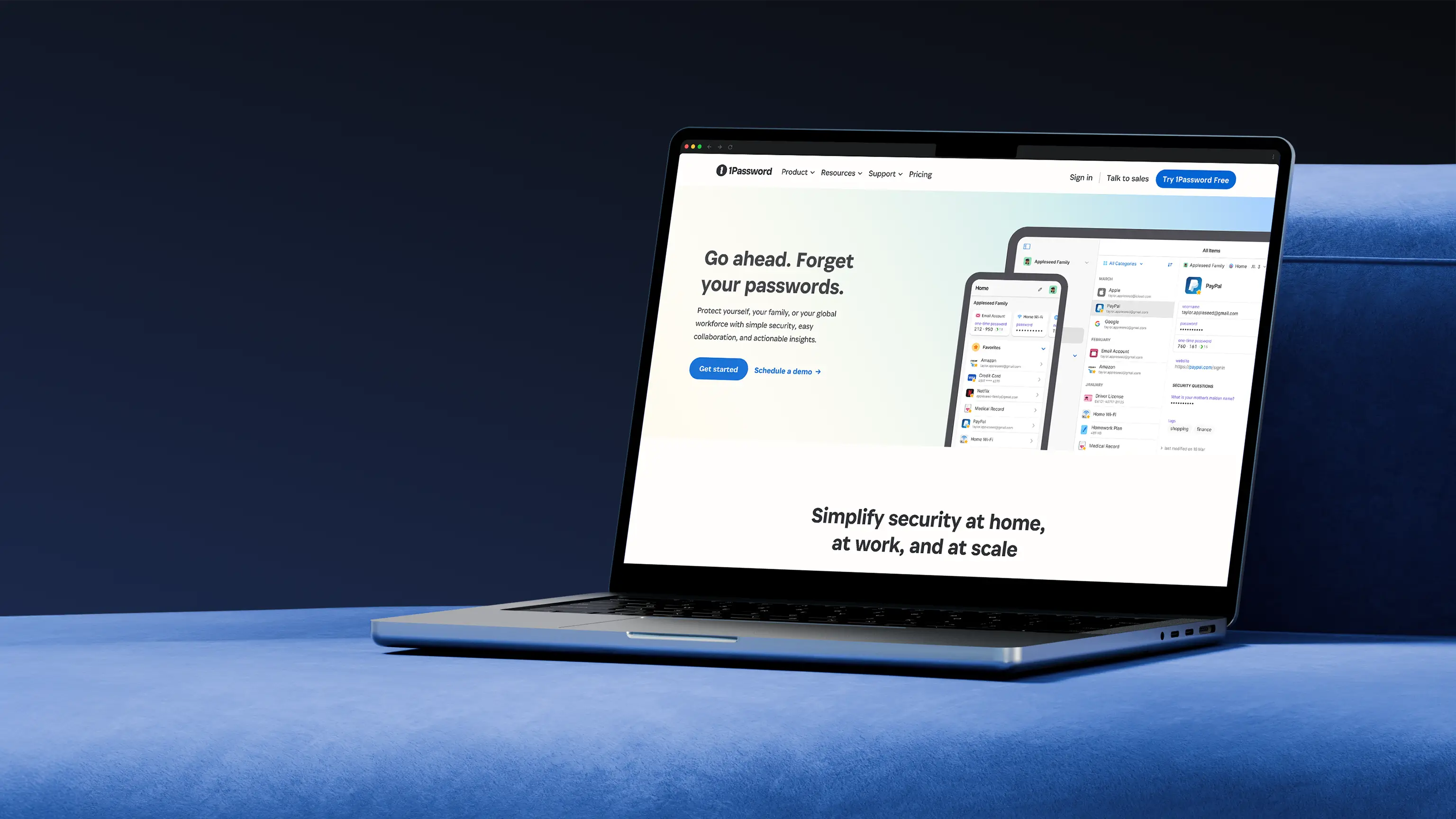 1Password homepage displayed on a MacBook Pro, resting on a blue fabric surface.