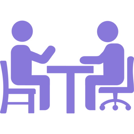 Icon of two people sitting across from each other at a table engaged in a meeting or discussion.