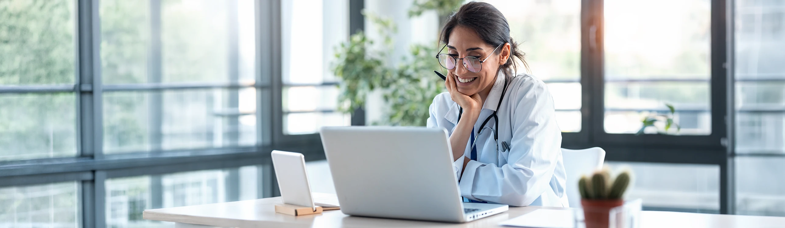 a picture of a doctor sitting at his computer