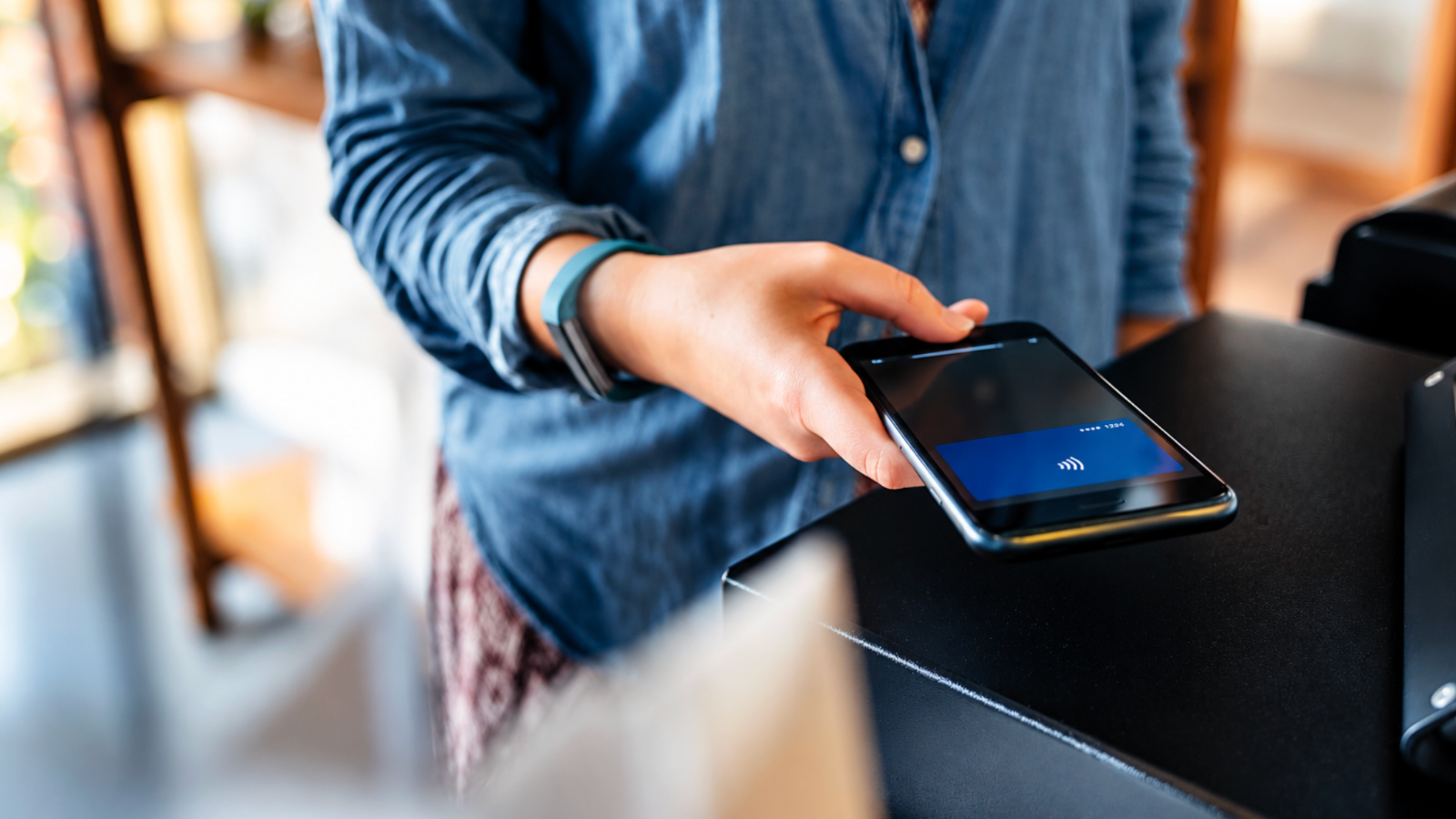 Smartphone digital wallet holding payment cards, loyalty cards, and offers