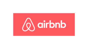 Airbnb logo with white text and symbol on a red background.