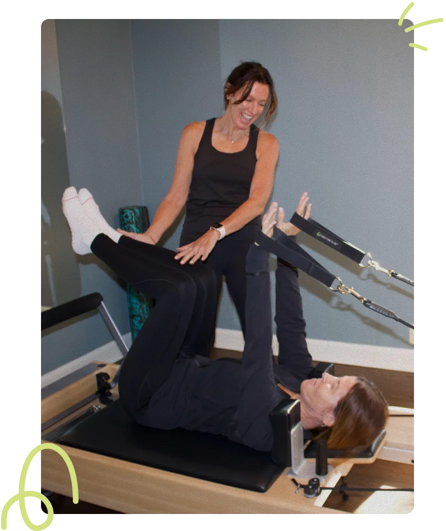 Christine Roher coaching a client through a private reformer Pilates session in her Northfield studio
