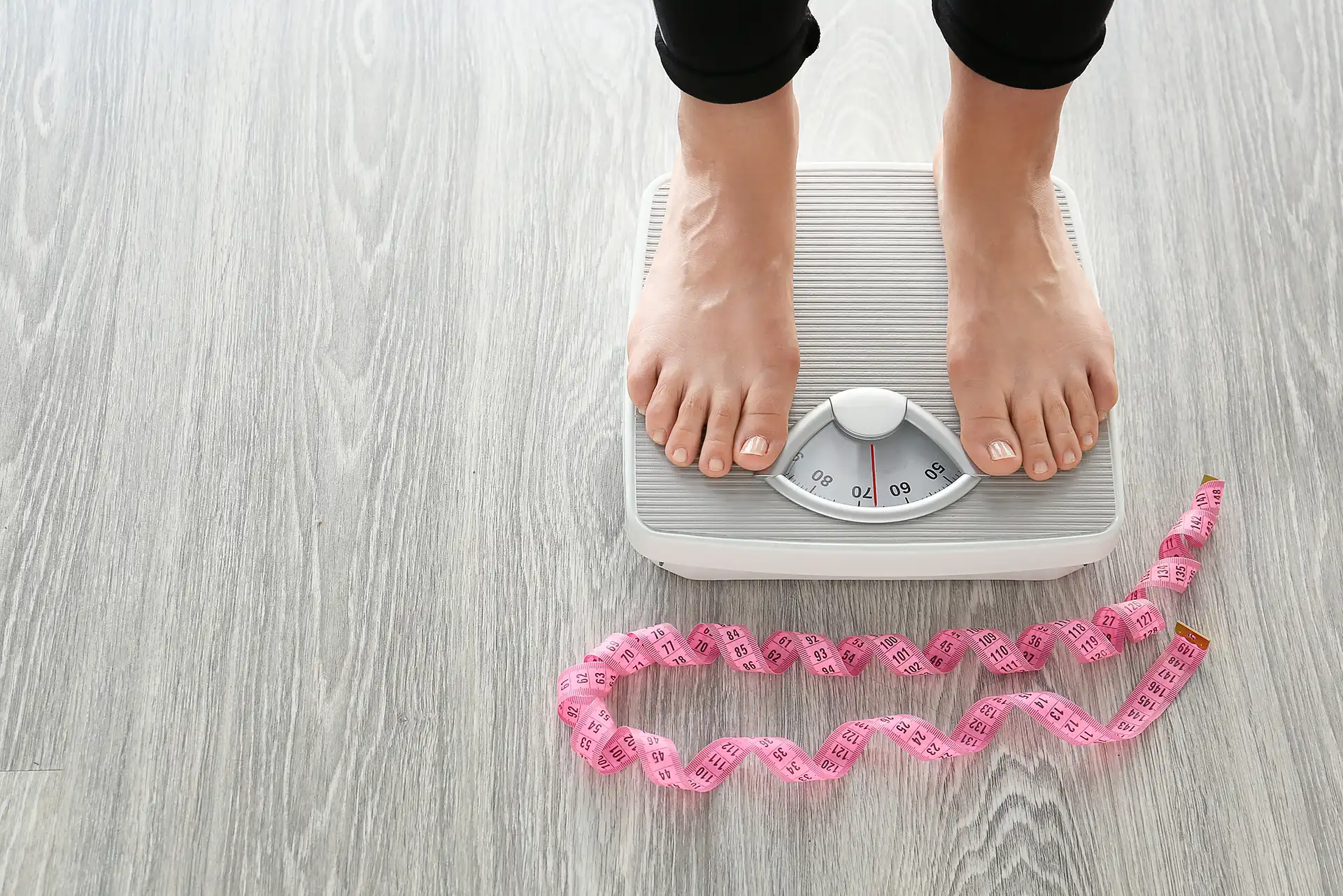 Close-up of feet on a scale