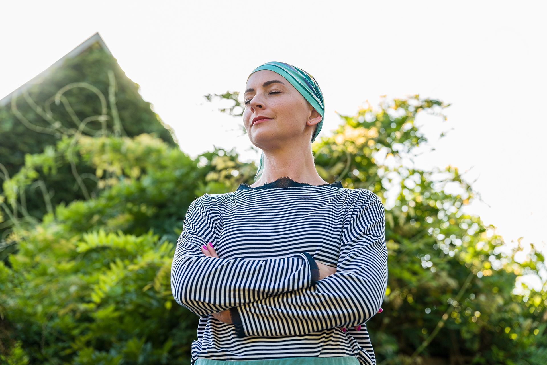 Women's hands holding a pink ribbon