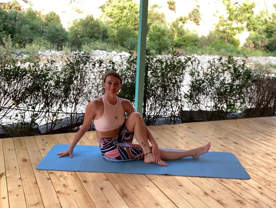 Tati sitting in the yoga shala smiling