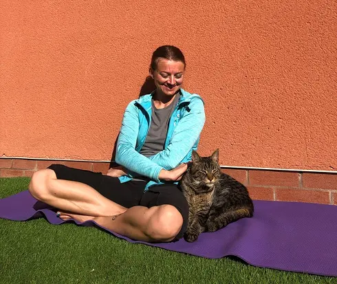 Tati enjoying the sun next to a cat
