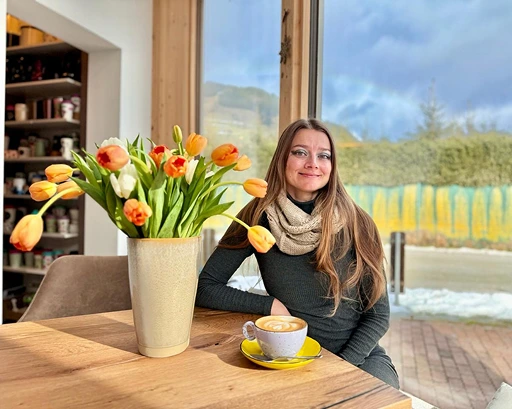 Tati with a cup of coffee and tulips