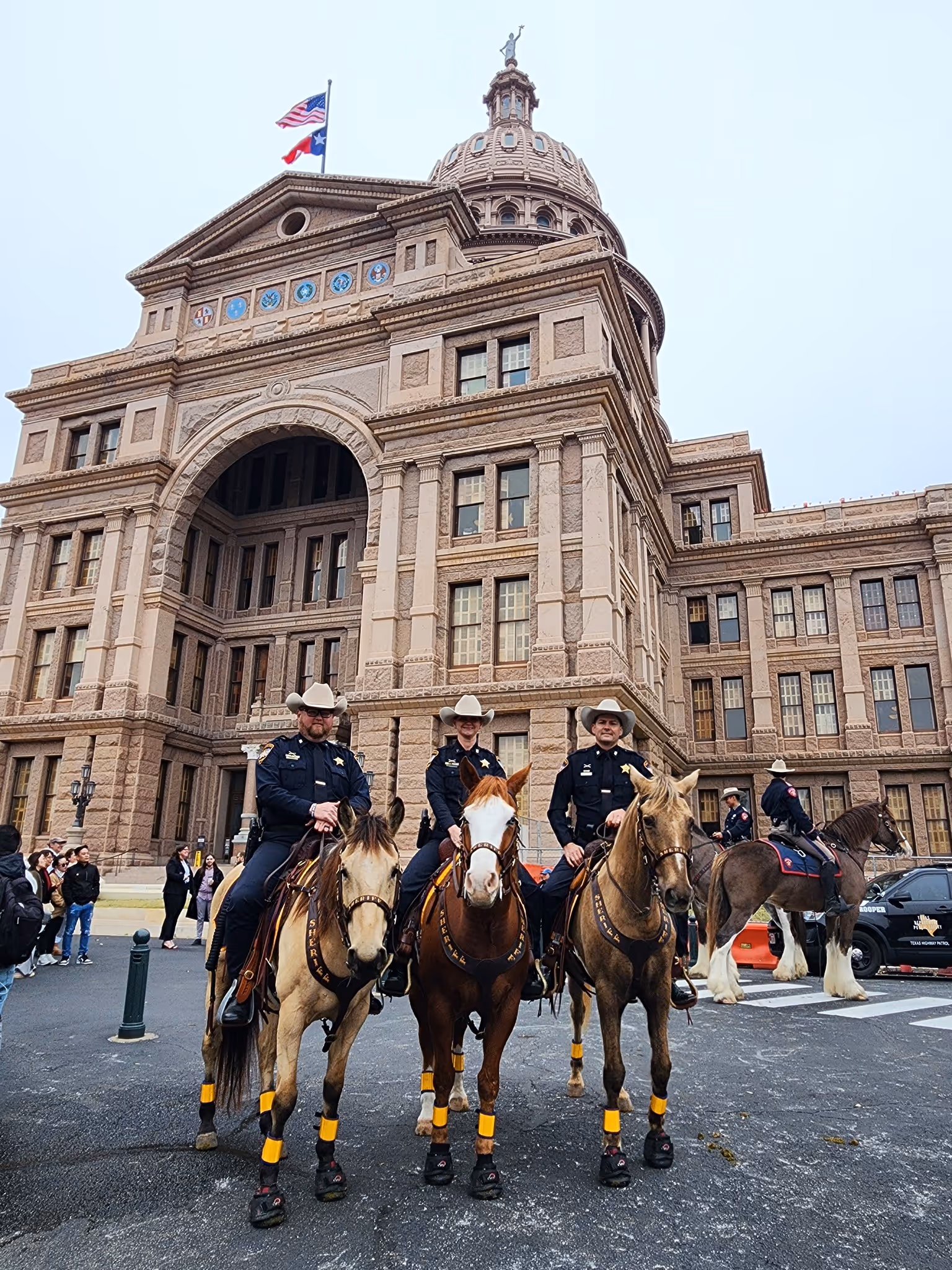 Montgomery County mounted patrol deputies on horseback in front of the Texas State Capitol building
