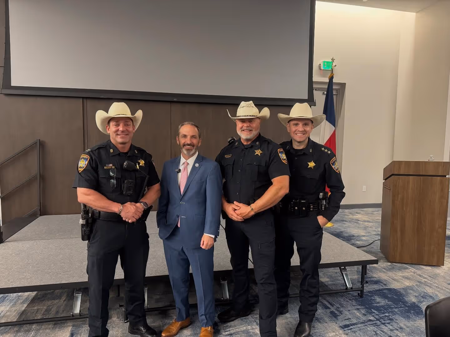 Montgomery County deputies standing with a community leader during an indoor event